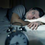 man in bed with eyes opened suffering insomnia sleep disorder